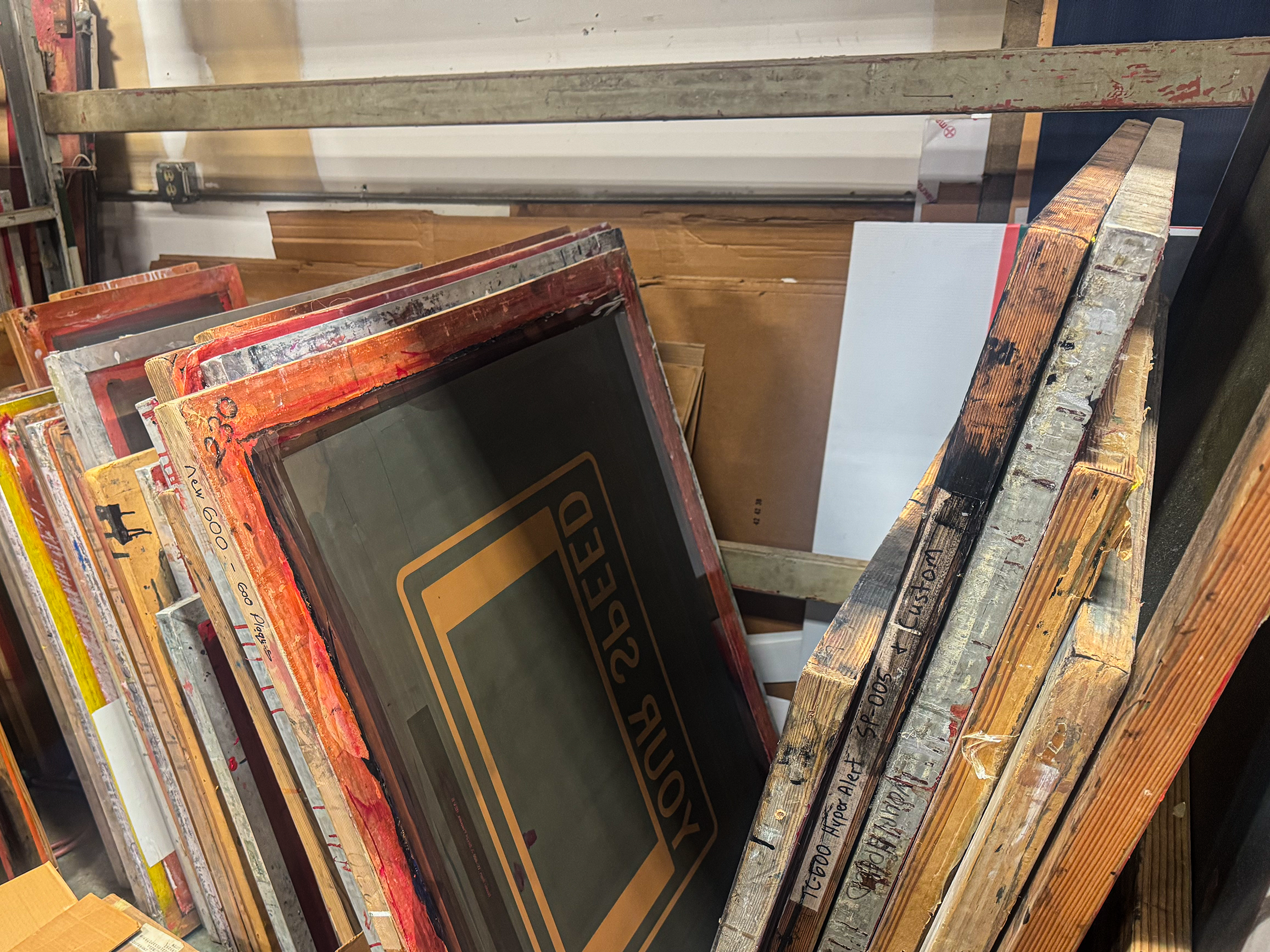 Stack of various wooden picture frames with different designs and sizes.