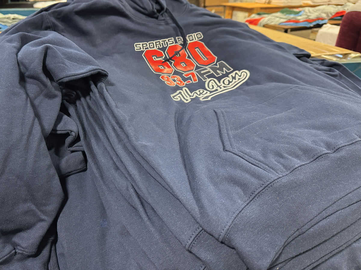 Gray hoodie with colorful text and logo on a table